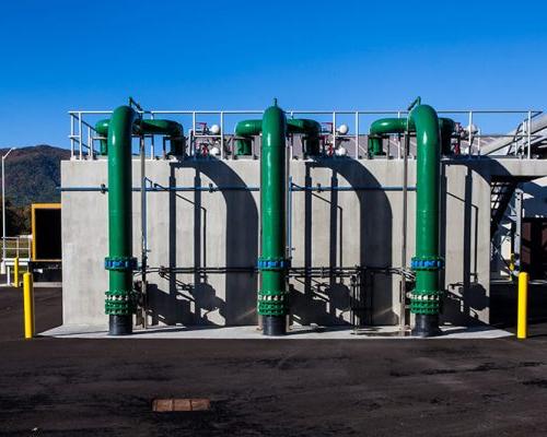 Green pipes outside the facility